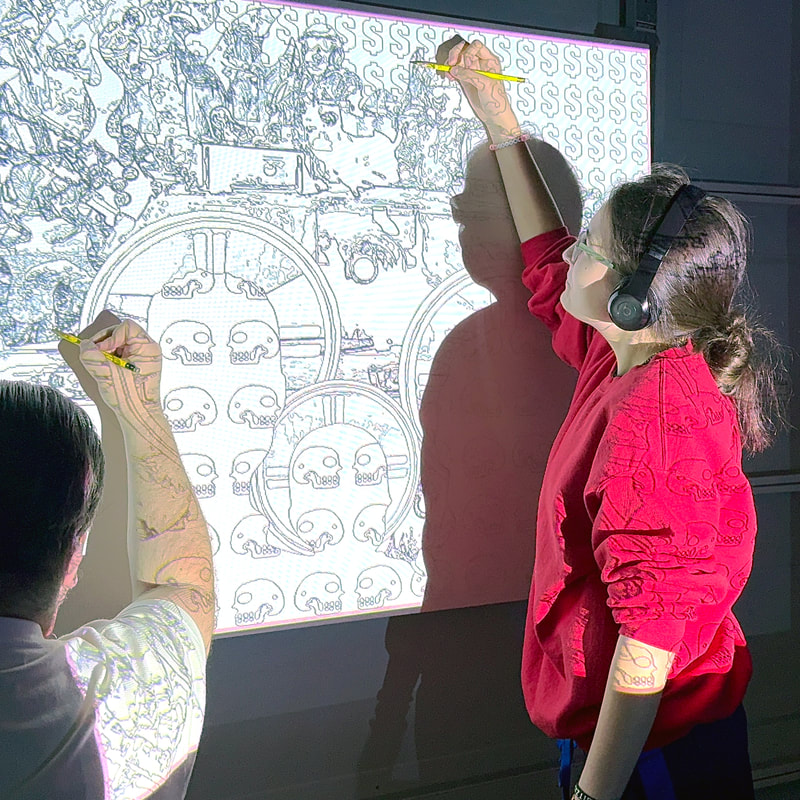 Photo of Chicano artist Roberto Valdes Sanchez (and his daughter) tracing the outline of "La Conquista" on a canvas.
