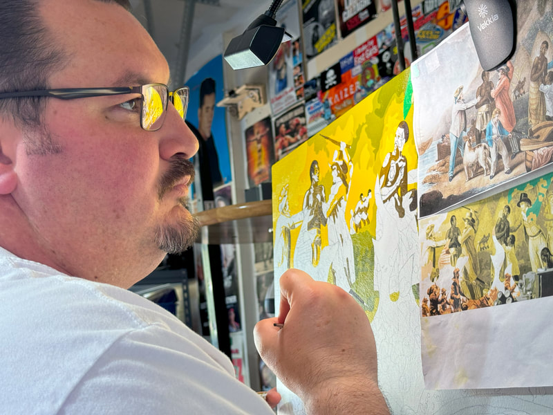 Close-up photo of Chicano artist Roberto Valdes Sanchez painting a scene depicting the European slave trade on a large canvas.