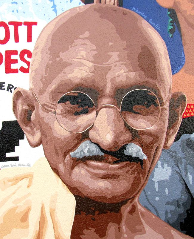 Mural art portrait painting of Indian human rights leader Mohandas (Mahatma) Gandhi, looking at the viewer and smiling.