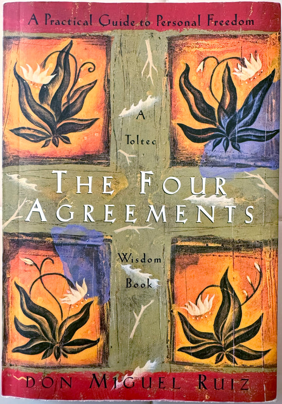 Front book cover of ‘The Four Agreements’ – promoting four simple adjustments we can make to our life that would improve our overall well-being – by Mexican author of Toltec spiritual wisdom Don Miguel Ruiz.